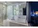 Modern bathroom with a soaking tub and glass enclosed shower featuring a view of the city skyline at 3726 S Las Vegas Blvd # 1107, Las Vegas, NV 89158