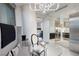 Inviting dining area with modern chandelier, glass table, and kitchen view, blending style and functionality at 3726 S Las Vegas Blvd # 1107, Las Vegas, NV 89158