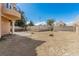 Large backyard with gravel landscaping and a block fence, offering privacy and potential for customization at 3789 Gershon Ct, Las Vegas, NV 89121
