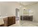 Bathroom featuring a walk-in shower with glass enclosure, dual sink vanities and tile flooring at 3789 Gershon Ct, Las Vegas, NV 89121
