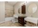 Modern bathroom with dual vanities, tiled floors, and a shower-over-tub with decorative tile surround at 3789 Gershon Ct, Las Vegas, NV 89121