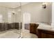 Bathroom with glass enclosed shower, tile floor and double vanity with marble countertop at 3789 Gershon Ct, Las Vegas, NV 89121