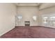 Large bedroom with a fireplace, natural light, and access to an outdoor balcony at 3789 Gershon Ct, Las Vegas, NV 89121