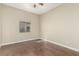 Bright bedroom with hardwood floors, a ceiling fan, and a large window offering ample natural light at 3789 Gershon Ct, Las Vegas, NV 89121