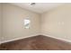 A bedroom featuring hardwood floors, a window with neighborhood view, and neutral colored walls at 3789 Gershon Ct, Las Vegas, NV 89121