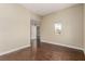 Bedroom with hardwood floors, a window with neighborhood view, and a doorway leading to other rooms at 3789 Gershon Ct, Las Vegas, NV 89121