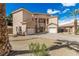Two-story home with brick driveway, three-car garage, and desert landscaping at 3789 Gershon Ct, Las Vegas, NV 89121