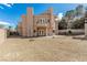 Back of a tan two-story home with a balcony, surrounded by gravel landscaping and a block fence at 3789 Gershon Ct, Las Vegas, NV 89121