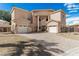Elegant home with a brick driveway, three-car garage, and desert landscaping at 3789 Gershon Ct, Las Vegas, NV 89121