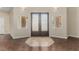 Inviting foyer featuring decorative double doors, modern lighting, and tile flooring at 3789 Gershon Ct, Las Vegas, NV 89121