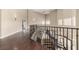 Open hallway with hardwood floors and ornamental iron stair railing at 3789 Gershon Ct, Las Vegas, NV 89121