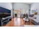 Cozy living room with hardwood floors, sofa, TV, and sliding doors to the backyard at 3812 Blue Dawn Dr, North Las Vegas, NV 89032