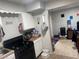 A functional kitchen featuring white cabinets and black appliances for cooking needs at 3934 Torsby Pl, Las Vegas, NV 89119