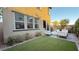 Inviting backyard with a lush lawn, patio area, and comfortable outdoor seating at 4181 Nopal Serrano Ave, Las Vegas, NV 89141