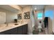 Modern bathroom with double sinks, sleek gray cabinets, and a bright, well-lit space at 4181 Nopal Serrano Ave, Las Vegas, NV 89141