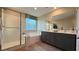 Modern bathroom featuring double vanity, walk-in shower, and a luxurious soaking tub at 4181 Nopal Serrano Ave, Las Vegas, NV 89141
