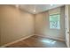 This bedroom features wood-look floors, neutral walls and a sunlit window at 4181 Nopal Serrano Ave, Las Vegas, NV 89141