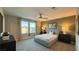 Serene bedroom with a ceiling fan, a comfortable bed, and large windows offering plenty of natural light at 4181 Nopal Serrano Ave, Las Vegas, NV 89141