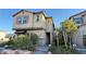 Charming two-story home with a neutral color palette, red shutters, and well-maintained landscaping at 4181 Nopal Serrano Ave, Las Vegas, NV 89141