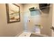 Functional laundry room with storage shelves, utility connections, and space-saving design at 4181 Nopal Serrano Ave, Las Vegas, NV 89141