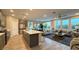 Open-concept living space with modern finishes, large windows, and a stylish kitchen island at 4181 Nopal Serrano Ave, Las Vegas, NV 89141