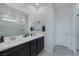 Bright bathroom with double vanity, large mirror, tiled shower, and modern fixtures at 4315 E Cactus Canyon Dr, Pahrump, NV 89061