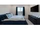 Bedroom featuring a large bed with blue accents, a window with curtains, and a black dresser with decor at 4315 E Cactus Canyon Dr, Pahrump, NV 89061