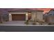 Charming single-story home featuring desert landscaping, a brick driveway and a two car garage at 4315 E Cactus Canyon Dr, Pahrump, NV 89061