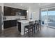 Modern kitchen with dark cabinets, quartz countertops, stainless steel appliances, and an island with bar seating at 4315 E Cactus Canyon Dr, Pahrump, NV 89061