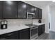 Updated kitchen with dark cabinetry, modern appliances, and bright countertops at 4315 E Cactus Canyon Dr, Pahrump, NV 89061