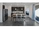 Bright kitchen featuring dark cabinets, quartz countertops, island, and stainless appliances at 4315 E Cactus Canyon Dr, Pahrump, NV 89061