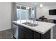 Bright kitchen island with stainless steel appliances and a view to the backyard through sliding glass doors at 4315 E Cactus Canyon Dr, Pahrump, NV 89061