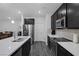 A kitchen is featured with stainless steel appliances and dark cabinetry, providing a modern and stylish design at 4315 E Cactus Canyon Dr, Pahrump, NV 89061