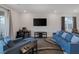 Cozy living room with a large screen television, desk, and comfortable blue sofa set at 4315 E Cactus Canyon Dr, Pahrump, NV 89061