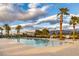 Resort-style pool with lounge chairs and palm trees against a scenic mountain backdrop at 4315 E Cactus Canyon Dr, Pahrump, NV 89061