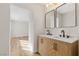 Renovated bathroom featuring double vanity with modern fixtures and wood-look flooring at 4921 E Washington Ave, Las Vegas, NV 89110
