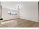 Bedroom with wood-look floors, natural light, and modern light fixture at 4921 E Washington Ave, Las Vegas, NV 89110