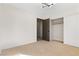 Bedroom with neutral carpet, closet, and ensuite bathroom at 4921 E Washington Ave, Las Vegas, NV 89110