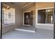 Covered front porch with security door and decorative window bars, offering a secure entrance at 4921 E Washington Ave, Las Vegas, NV 89110