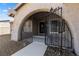 Arched entry with security gate, leading to the front door of this charming home at 4921 E Washington Ave, Las Vegas, NV 89110