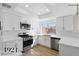 Modern kitchen featuring stainless steel appliances, white cabinets, and beautiful quartz countertops at 4921 E Washington Ave, Las Vegas, NV 89110