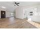 Open-concept living room showcasing modern kitchen and wood-look floors throughout at 4921 E Washington Ave, Las Vegas, NV 89110