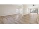Bright, open living space with wood-look flooring, vaulted ceilings, and a view to the kitchen at 4921 E Washington Ave, Las Vegas, NV 89110