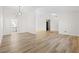 Open-concept living room featuring wood-look flooring and neutral color palette at 4921 E Washington Ave, Las Vegas, NV 89110