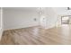 Open floorplan showcasing wood-look flooring, vaulted ceiling, and access to the kitchen and backyard at 4921 E Washington Ave, Las Vegas, NV 89110