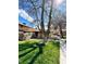 Charming home with well-maintained lawn, mature tree, and sidewalk to entrance at 5083 Village Dr, Las Vegas, NV 89142