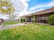 Expansive backyard with manicured lawn, covered patio and lush landscaping at 5340 N Campbell Rd, Las Vegas, NV 89149