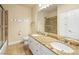 Bathroom featuring double sinks with granite countertops and a glass shower door at 5340 N Campbell Rd, Las Vegas, NV 89149