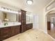 Bright bathroom features dual vanities, a well-lit mirror, and tile flooring throughout at 5340 N Campbell Rd, Las Vegas, NV 89149