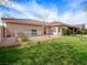 Lawn and home exterior featuring a side entry, mature landscaping, and a tile roof at 5340 N Campbell Rd, Las Vegas, NV 89149